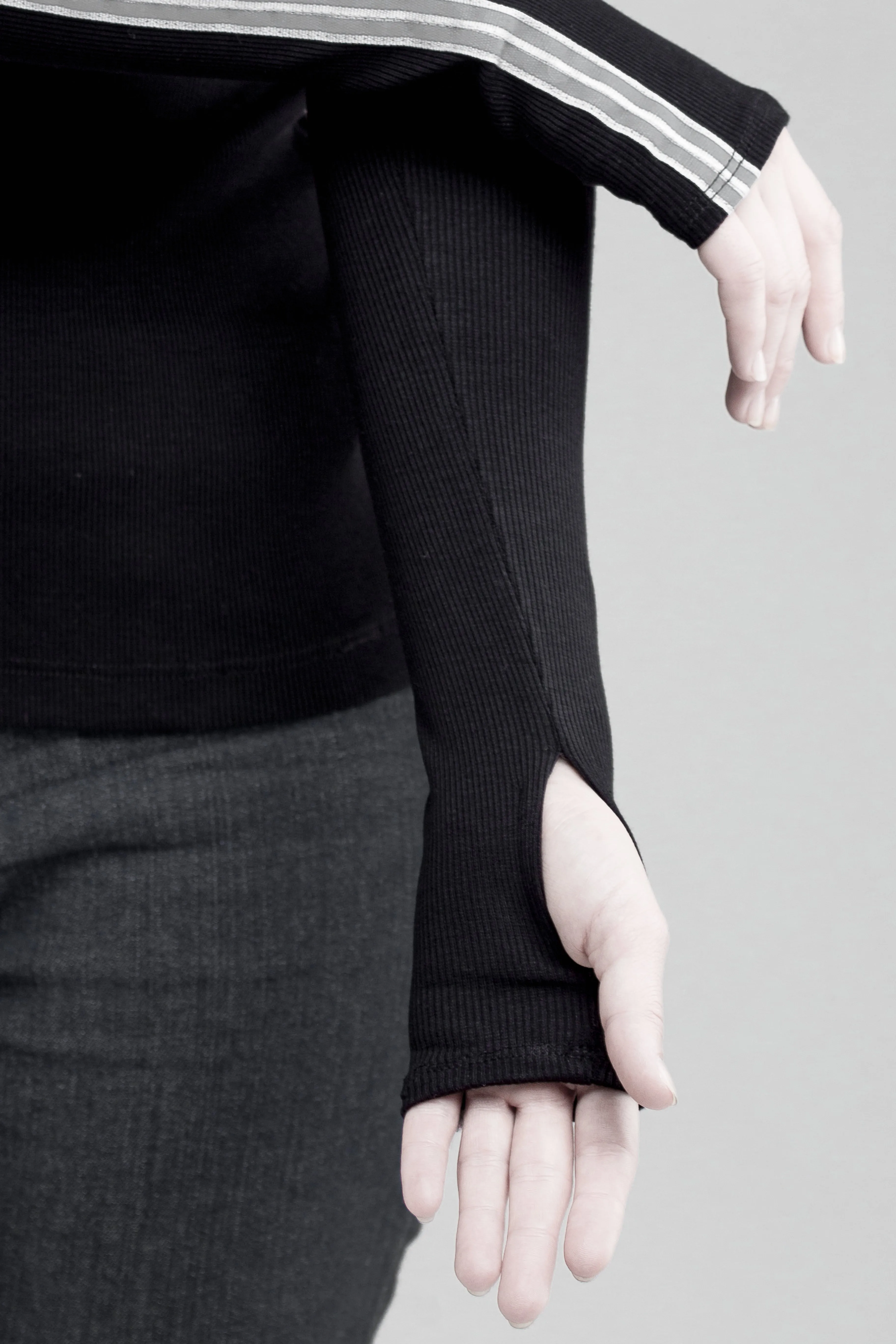 Black sleeveless turtleneck top with long fingerless gloves